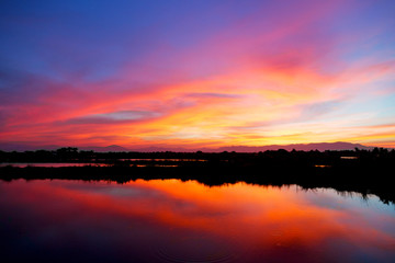 Fototapeta na wymiar view from water of the sunrise full of colors