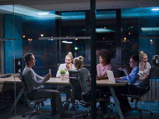 Multiethnic startup business team in night office