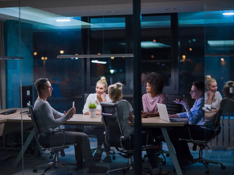 Multiethnic startup business team in night office
