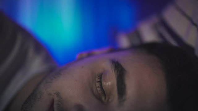 Man waking up in bed, insomnia, poor sleep. 4K