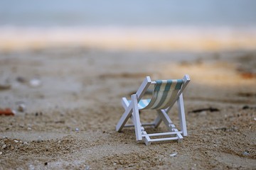 Fototapeta na wymiar Beach chair on sandy beach tropical summer holidays with blur ocean background