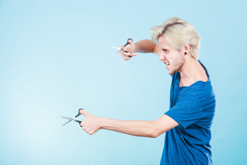 Man with scissors for haircutting