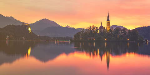 Fototapeta na wymiar Fairytale, multi-colored dawn over Lake Bled in Slovenia,vintage retro color tone