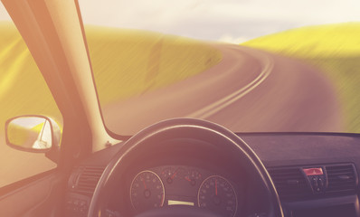 View from the interior of a car driving on an asphalt road ,vintage retro color tone