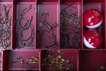 Tackle box for fishing with hooks and bobbers © Mat Hayward