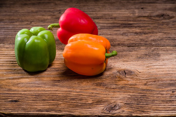 Colorful bell peppers on rustic table