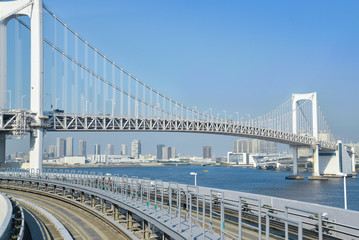 Obraz premium Rainbow bridge as seen from Yurikamome train, Odaiba, Japan