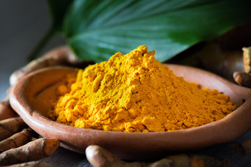 Turmeric powder on wooden background