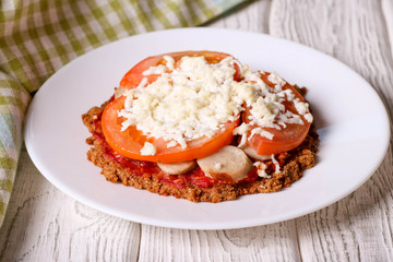 Healthy pizza with sausage, cheese and tomato