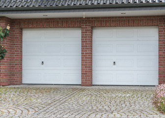 Doppelgarage mit weißen Toren