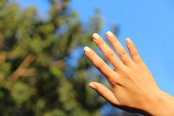 Hands of a woman with nail polish on her nails