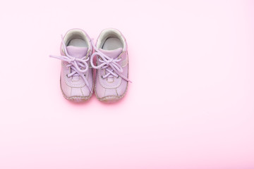 baby pink shoes on the pink background. flat lay