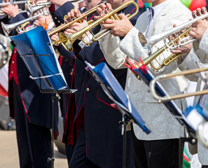 musical orchestra performing during the fest. musicians playing trumpets.