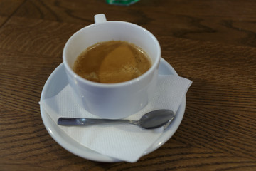Cup of coffee for a business lunch on a wooden table