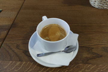 Cup of coffee for a business lunch on a wooden table