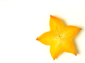 Fototapeta premium Close-up of orange yellow color sliced ripe Star Fruit on white background, with free space for design and text 