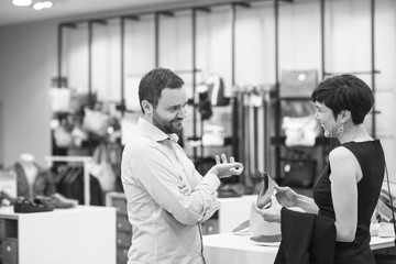 couple chooses shoes At Shoe Store