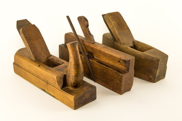 Three  wooden vintage woodwork planes on white background