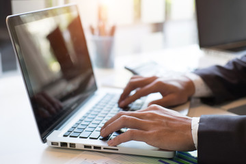 Closeup businessman working plan the business and analysis on laptop. Film effected photo.