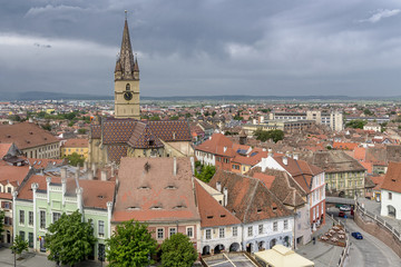 Obraz premium Breathtaking aerial view on the famous Piata Mica, Small Square, from the top of the Council Tower, in the historic center of Sibiu, Romania, with the Saint Mary Cathedral in the background