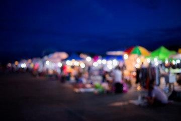 Blurred background of people shopping at night festival with bokeh