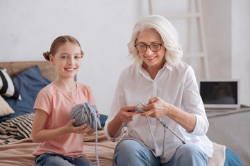 Fototapeta premium Pretty young girl helping her grandmother