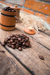 Coffee beans in a barrel on a wooden.