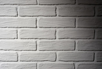 Fototapeta premium white brick wall with light effect and shadow, abstract background photo
