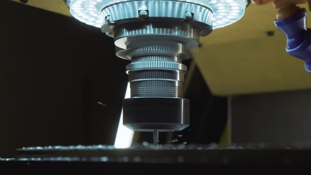 CNC milling machine proceccing metal detail. Super slow motion. Cutting metal modern processing technology.
