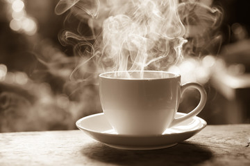 cup of hot coffee with smoke in sepia tone  
