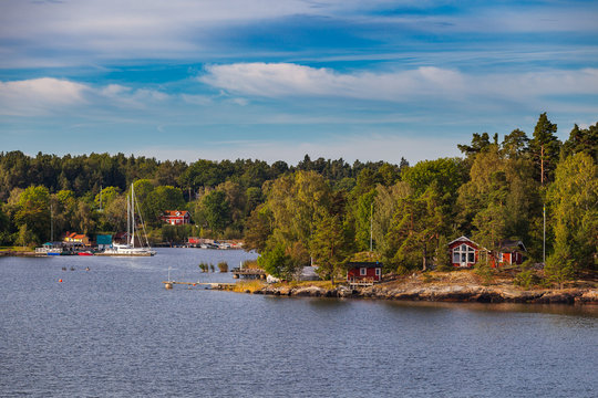 View on small cabins on an island in Stockholm archipelago, Sweden. Summer sunrise time.