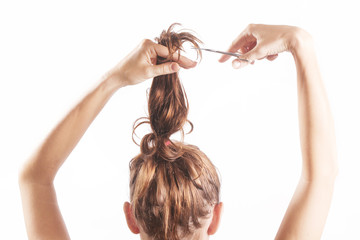 Woman cutting her ponytail 