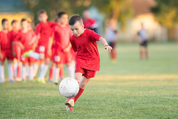 Kids soccer football - children players match on soccer field