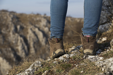 Hiking boot closeup on mountain rocks