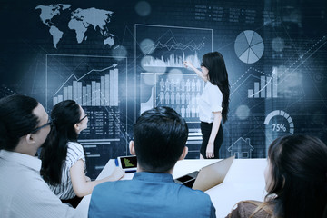 Young businesswoman explains financial chart