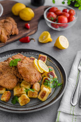 Schnitzel original with lemon and gnocchi fried