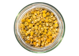 Chamomile herb in glass bottle top view