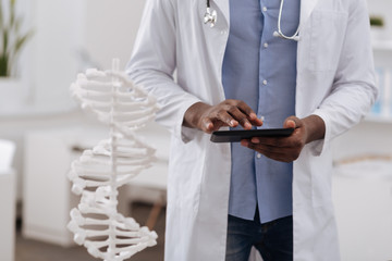 Professional male biologist using a tablet