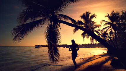 Sea sunrise. Girl running on the tropical island beach Punta Cana