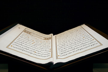 Holy Quran illuminated by the sun. Closeup of Islamic Book Holy Quran  - obrazy, fototapety, plakaty