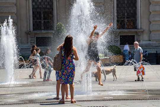 people jumping funtain in hot summer