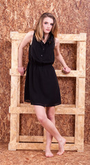 Obraz na płótnie Canvas Full body Beautiful woman fashion style posing on wooden wall in studio photo. Style and vogue