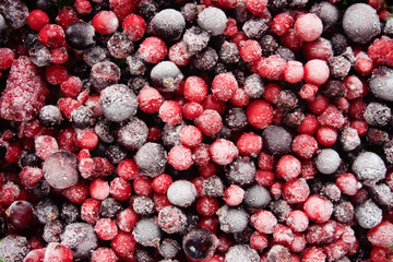 Top view of blue and red frozen berries.