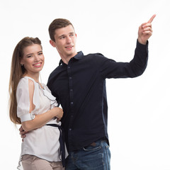 Young happy couple showing presentation pointing on placard over