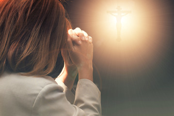 Woman hands praying in the dark - 160476210