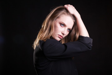 Fototapeta premium Portrait of woman in casual fashion clothes in studio photo on black background. Sexyality and sensuality