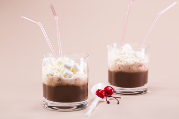 Two glasses of cocoa with whipped cream and marshmallows