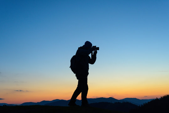 Nature photographer taking photos in the mountains

