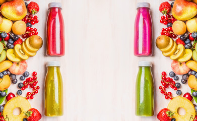 Red,pink,green and yellow smoothies and juices beverages in bottles with various fresh organic...