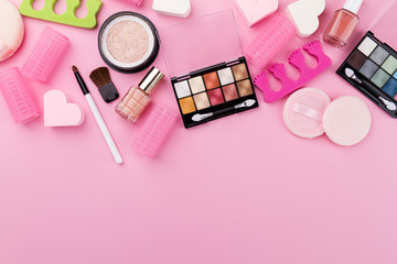 Obraz na płótnie Canvas Beauty Spa Feminine Concept. Different Make Up Beauty Care Essentials Cosmetics on Flat Lay Pink Background. Top View. Above.